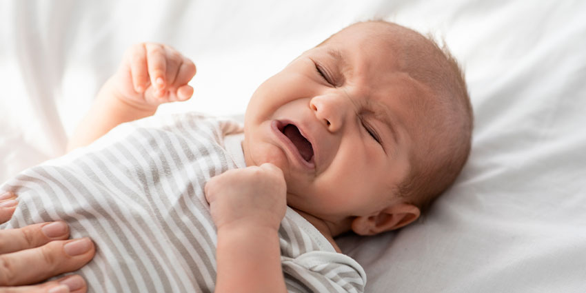 Patient suffering from Colic in need of Chiropractic care at By Design Chiropractic in Ponderay