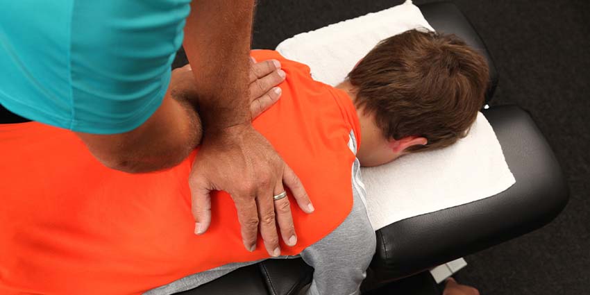Patient recieving Drop Technique at By Design Chiropractic in Ponderay for pain relief